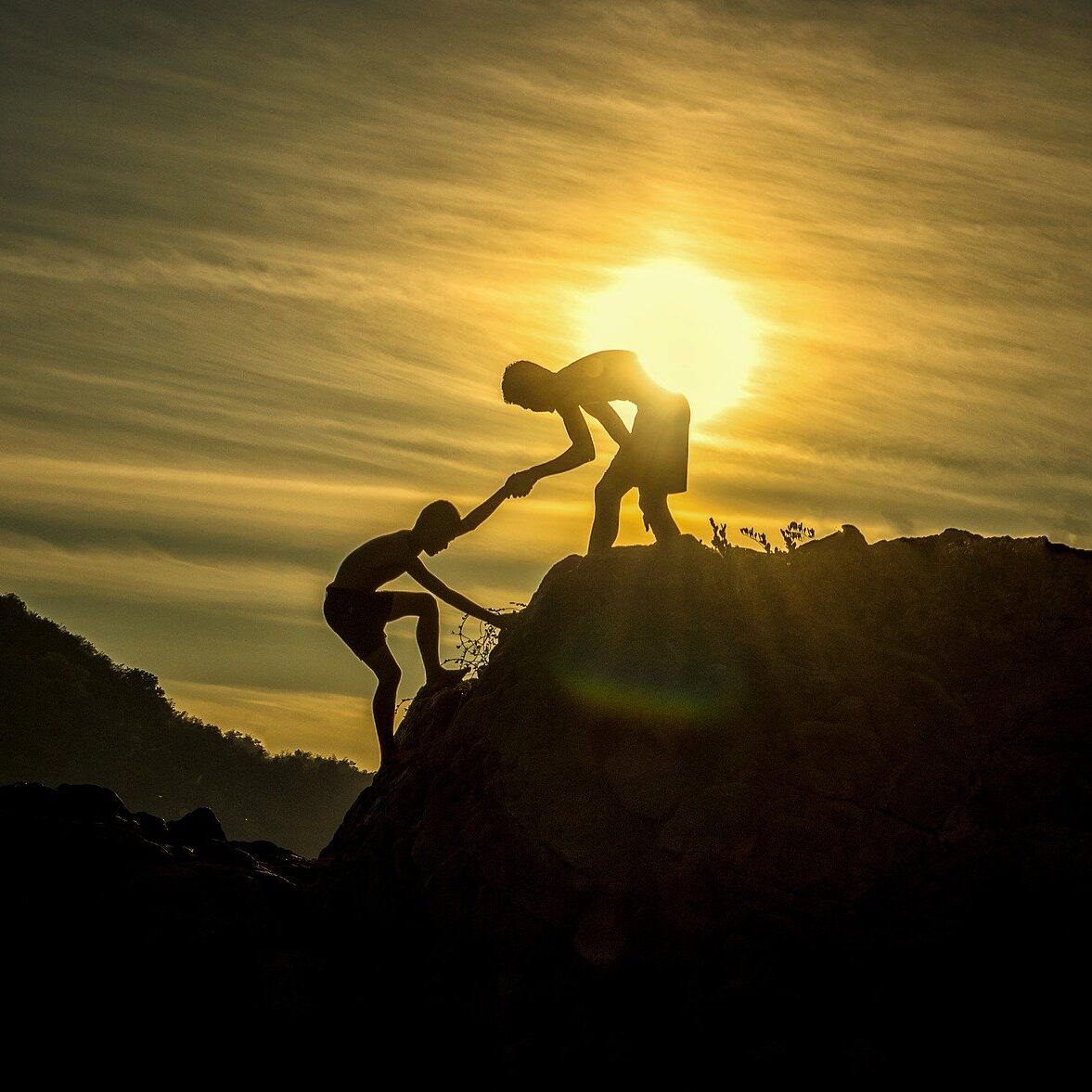 Coaching and Consultancy image - on man helping another man up a hill